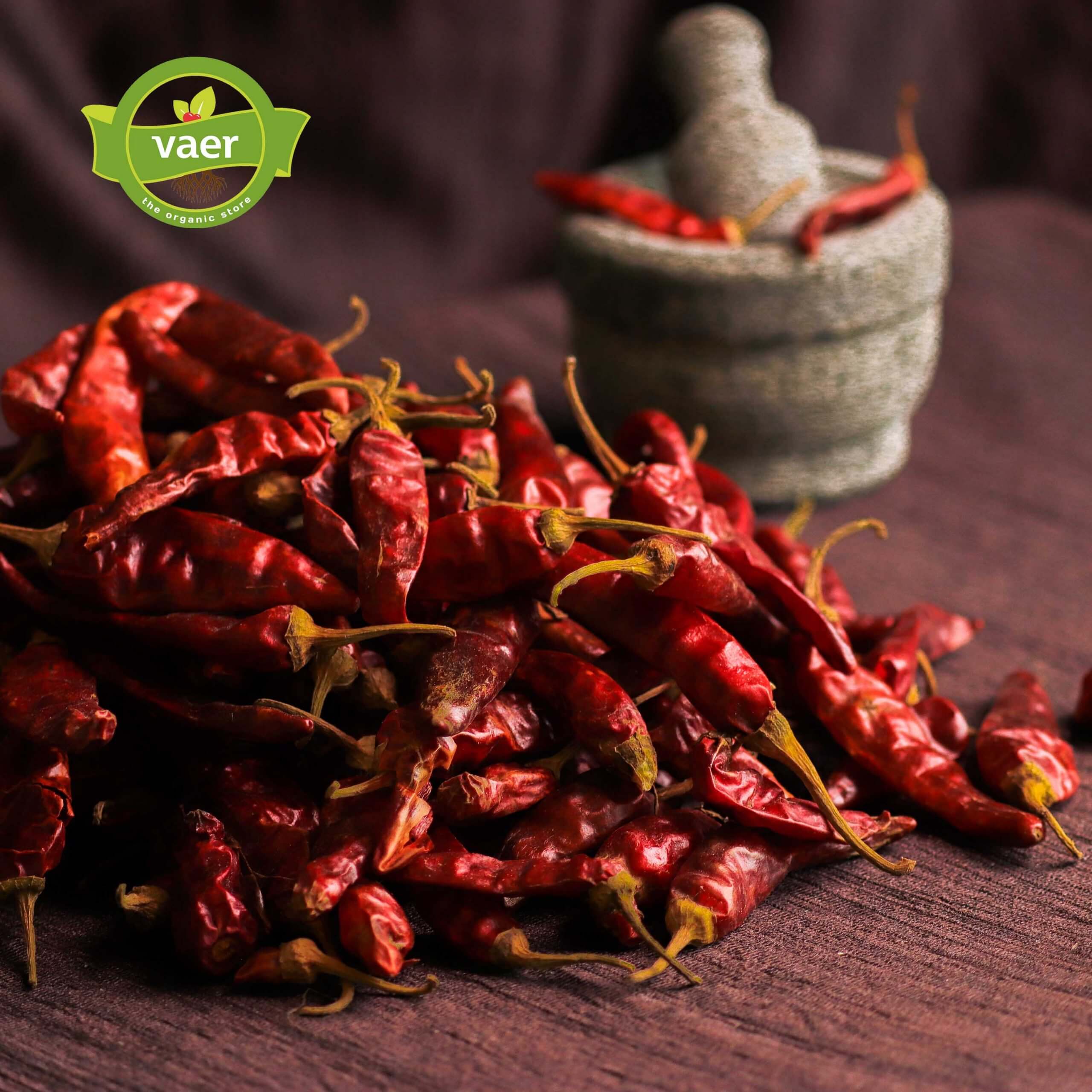 Vibrant red dried chillies heaped in a traditional basket